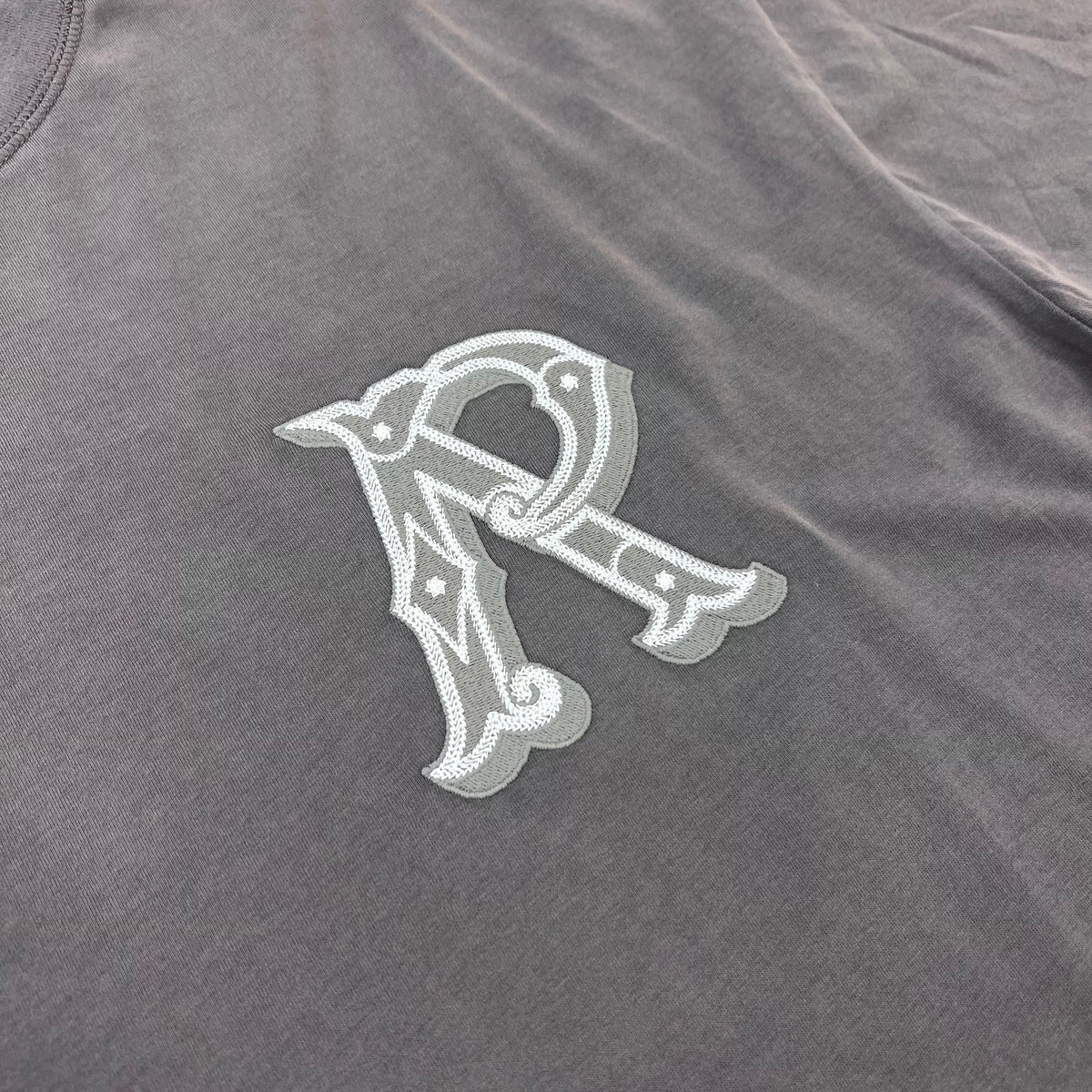 Represent 'Western Initials' T-Shirt in Flat White - Embroidered logo detail.