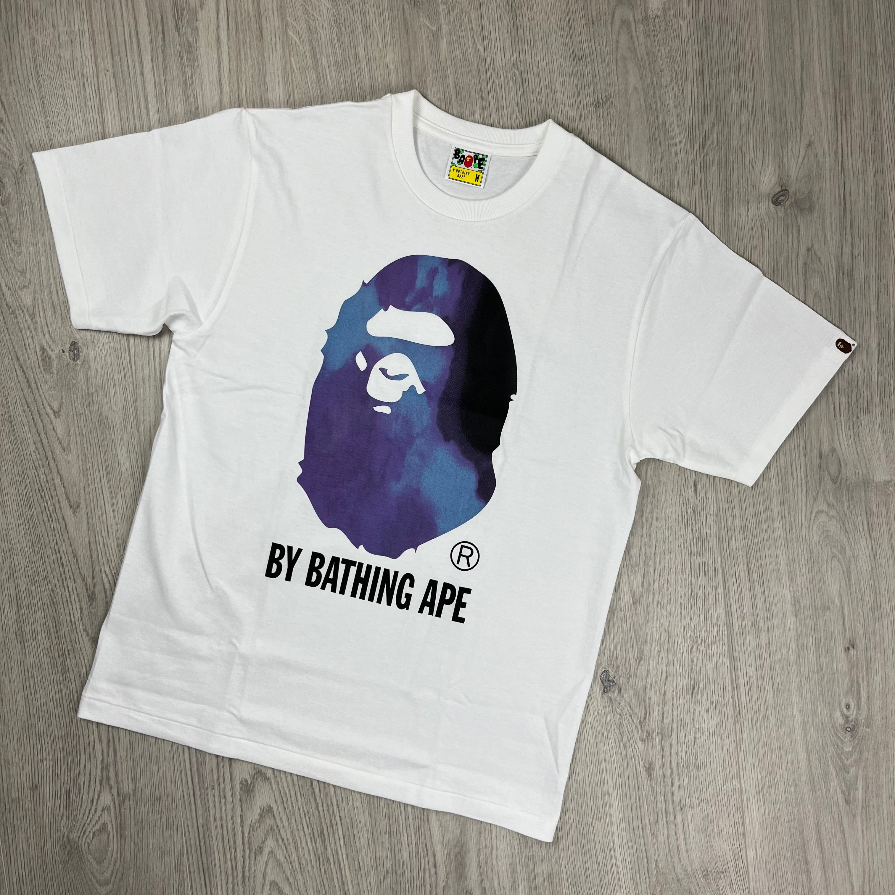 A Bathing Ape 'Ape Head' Tie Dye T-Shirt in White. On sale at Open Attire. 