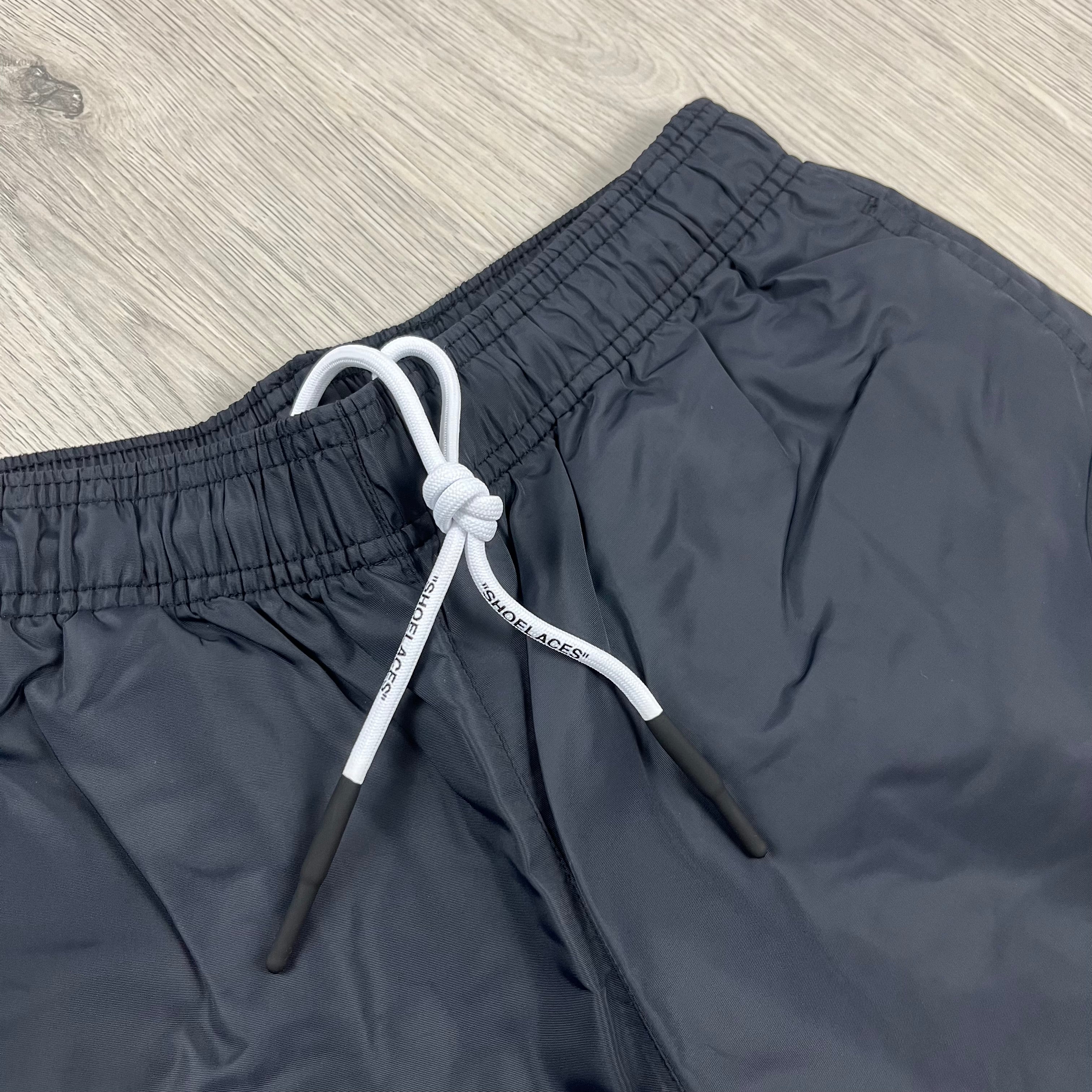 Off-White c/o Virgil Abloh Arrow Swim Shorts in Black. On sale at Open Attire.