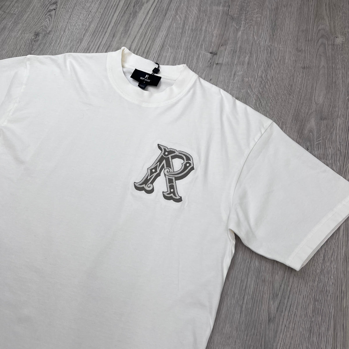 Represent 'Western Initials' T-Shirt in Flat White - Angled view.