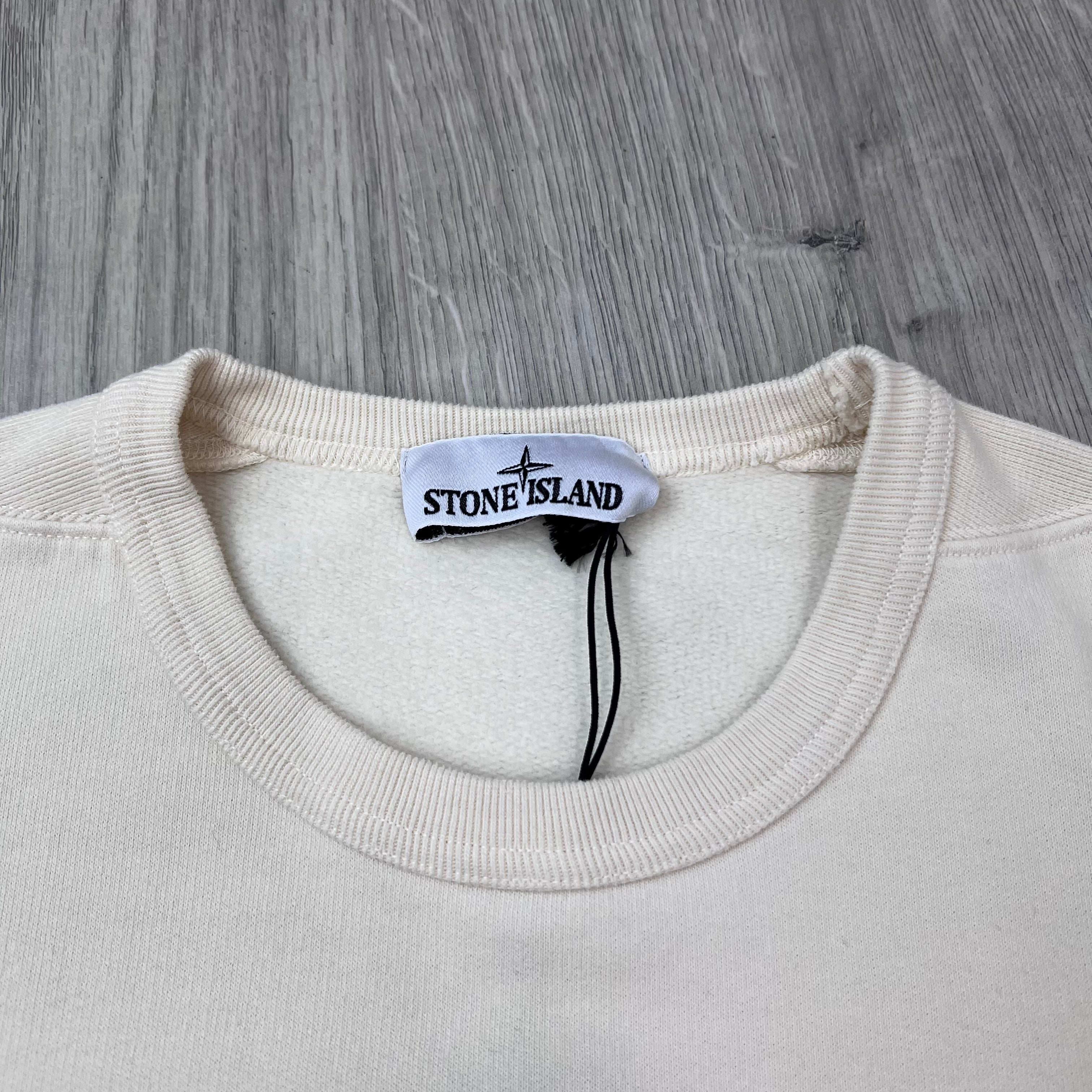 A close up view of the crewneck collar on a Stone Island Crewneck Brushed Cotton Sweatshirt in Ivory.