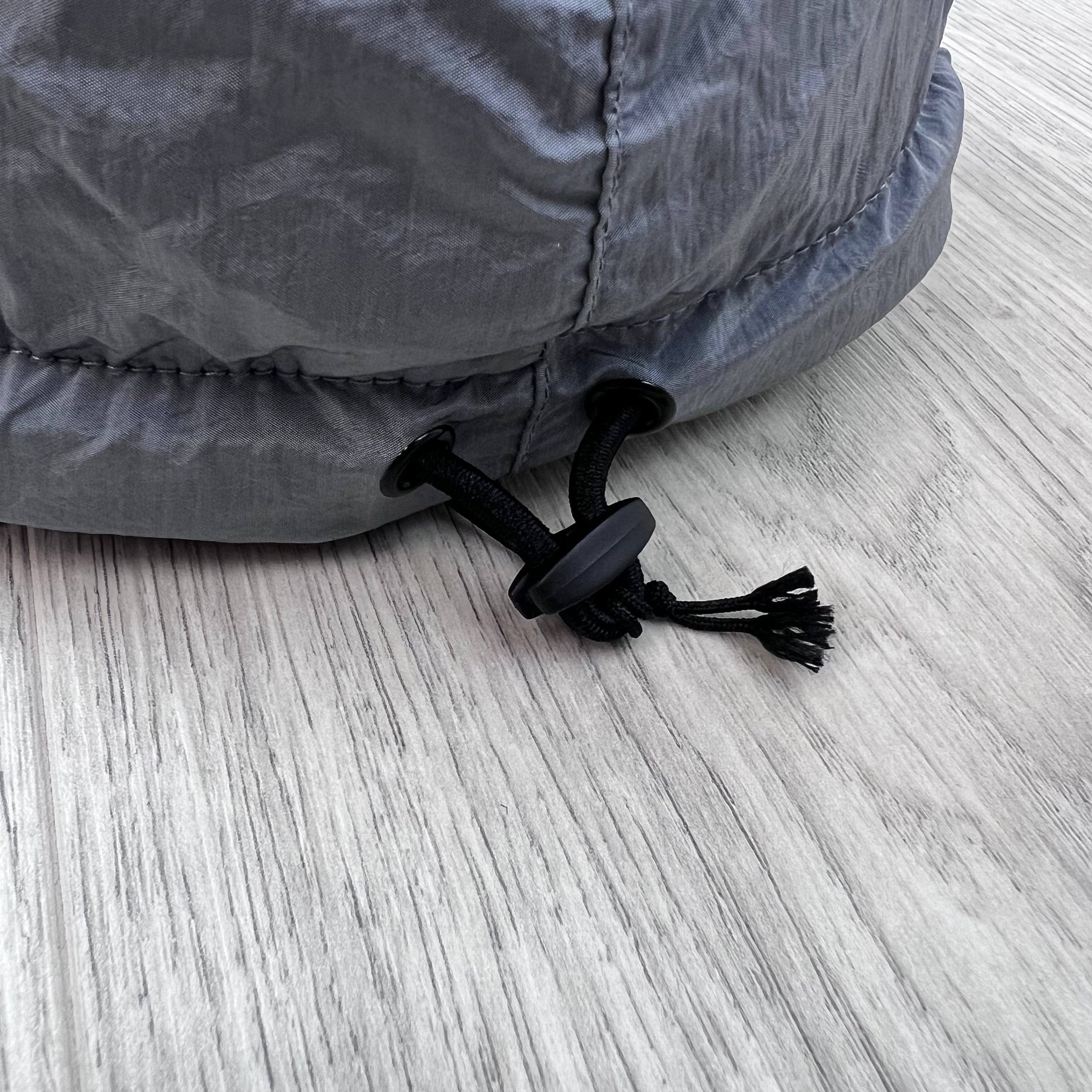 Close up view of the adjustable toggle on a Stone Island Nylon Metal Baseball Cap in Ash Grey.