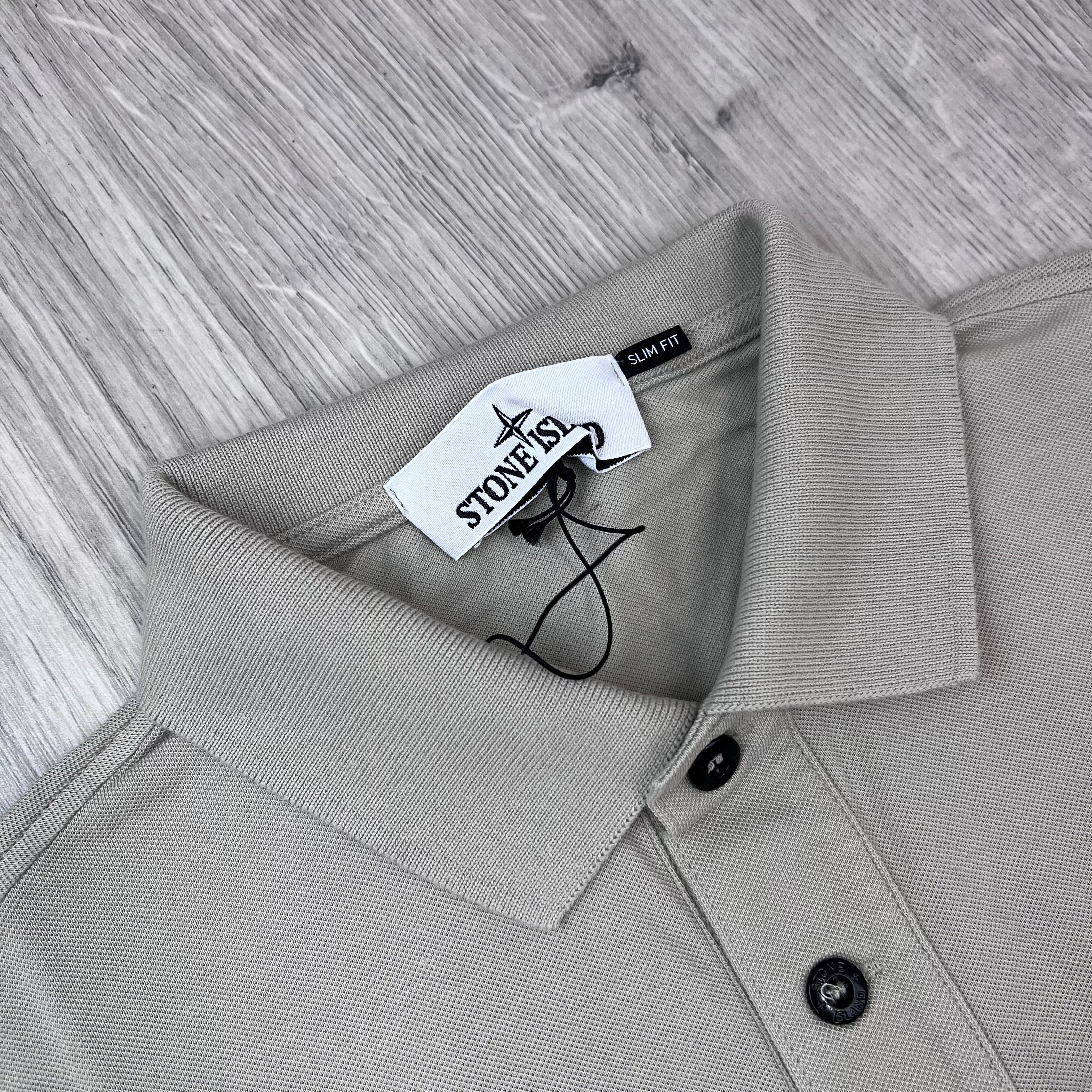 A close up view of the neck and collar on a Stone Island Patch Polo Shirt in Sand.
